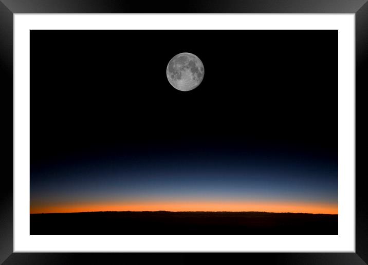 Near full moon against a sunrise from an aircraft Framed Mounted Print by Gordon Dixon