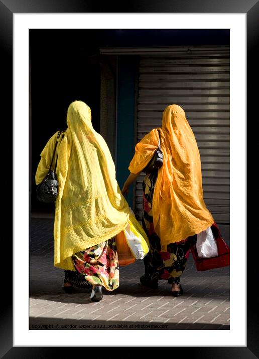 Ladies shopping in Dubai brightly coloured Framed Mounted Print by Gordon Dixon