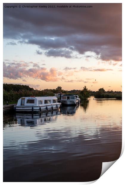 Sunset over Norfolk Broads boats Print by Christopher Keeley