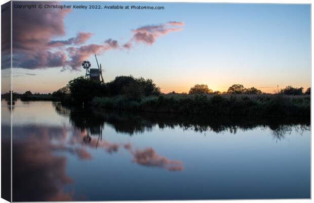 Sunset reflections at Turf Fen windpump Canvas Print by Christopher Keeley