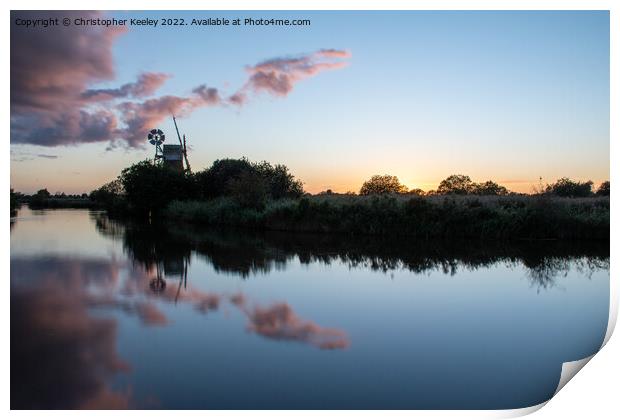 Sunset reflections at Turf Fen windpump Print by Christopher Keeley