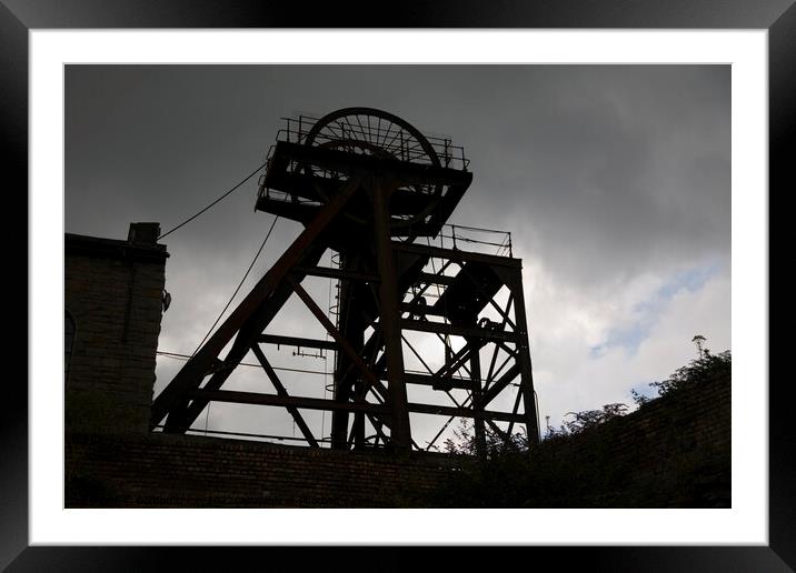 Silhouette of abandoned pit head winding gear, South Wales Framed Mounted Print by Gordon Dixon