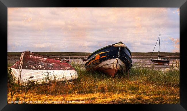 Abandoned boats on the shore of Lindisfarne, Holy Island, Northumberland, England Framed Print by Linda Webb