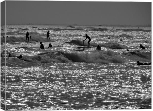 Surfboarders and Swimmers in Silhouette Canvas Print by Errol D'Souza
