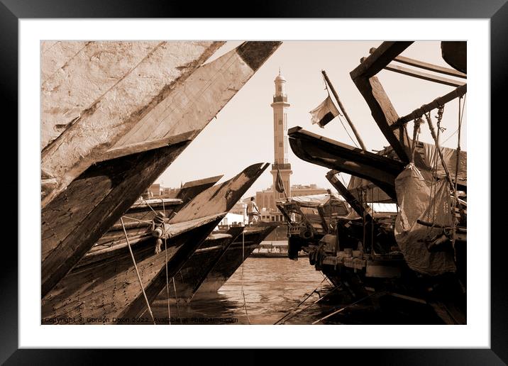 A man stands on a dhow Dubai Creek.  Framed Mounted Print by Gordon Dixon