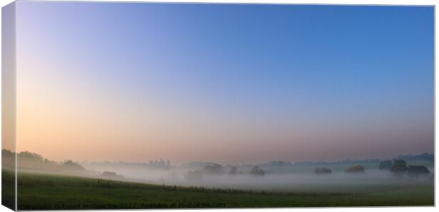 Misty morning sunrise Canvas Print by David McGeachie