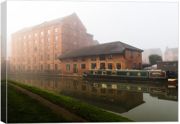 Mist over the old warehouse Canvas Print by Clive Wells