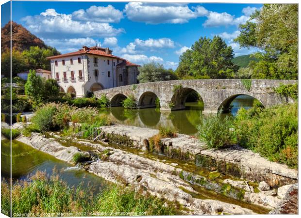 Serene Bridge and Monastery in Cantabria Canvas Print by Roger Mechan