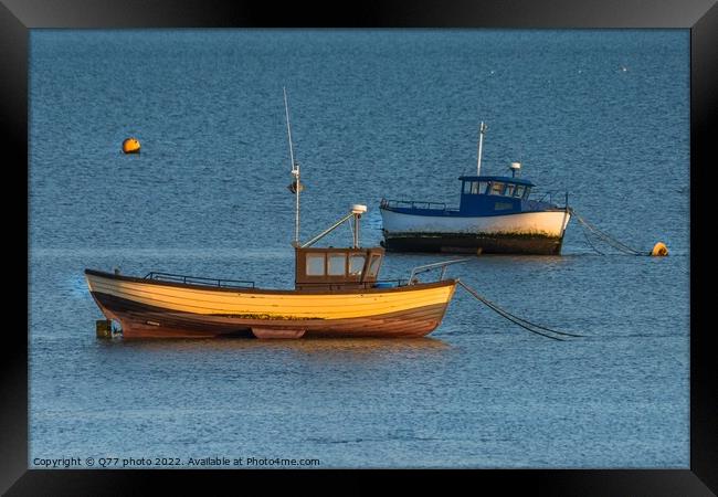 Moored boat illuminated by the rays of the setting sun on the shoal during low tide Framed Print by Q77 photo