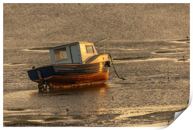 Moored boat illuminated by the rays of the setting sun on the shoal during low tide Print by Q77 photo