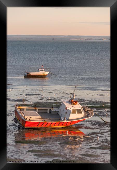 Moored boat illuminated by the rays of the setting sun on the sh Framed Print by Q77 photo