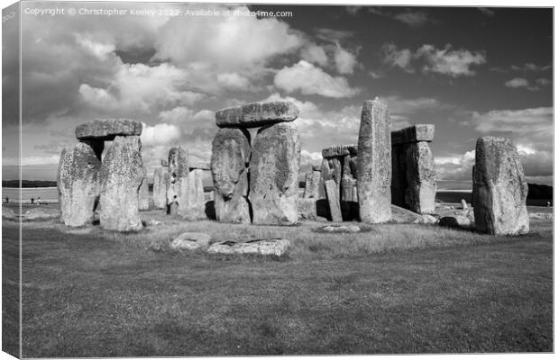 Cloudy skies over Stonehenge in black and white Canvas Print by Christopher Keeley