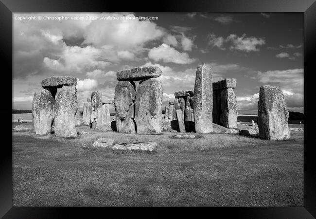 Cloudy skies over Stonehenge in black and white Framed Print by Christopher Keeley
