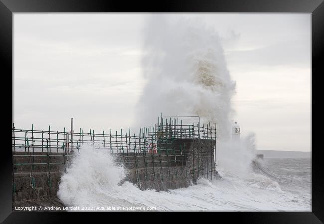Waves crash over Porthcawl lighthouse Framed Print by Andrew Bartlett