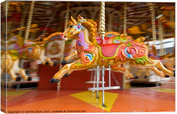 Carousel horses in action at the seaside Canvas Print by Gordon Dixon