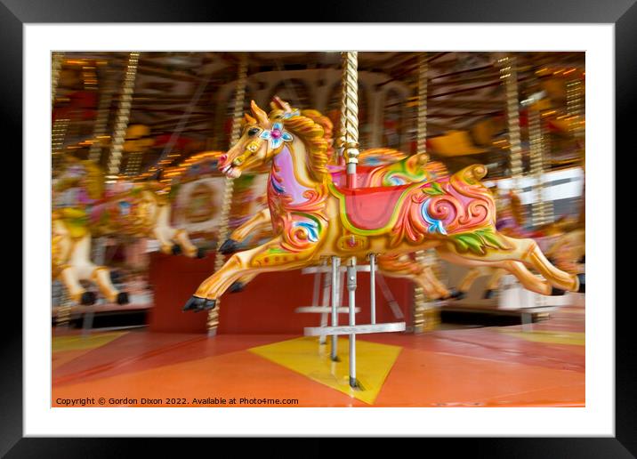 Carousel horses in action at the seaside Framed Mounted Print by Gordon Dixon