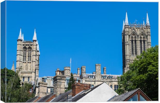 Lincoln cathedral peaks above the city skyline Canvas Print by Jason Wells