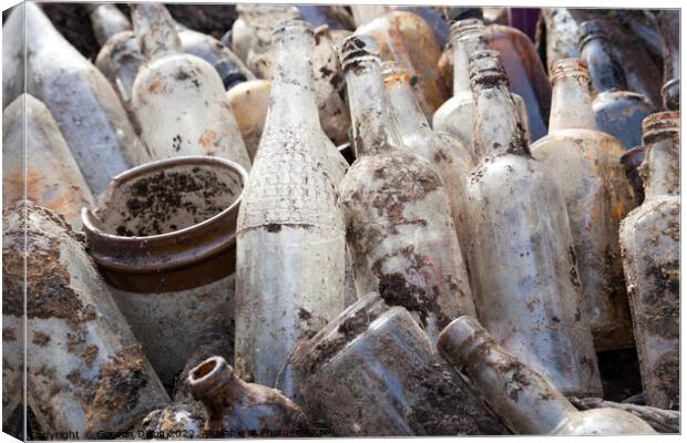 A selection of old glass bottles excavated from a building site in Surrey Canvas Print by Gordon Dixon