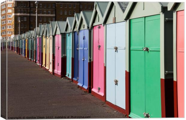 A row of beach huts stretching to infinity (almost) on the seafront - Brighton and Hove Canvas Print by Gordon Dixon