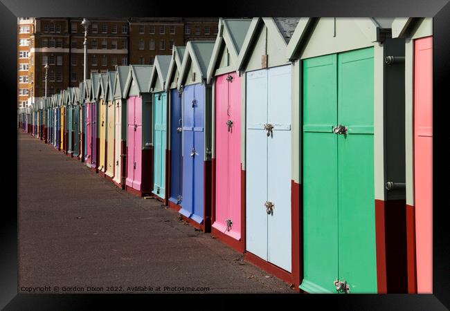 A row of beach huts stretching to infinity (almost) on the seafront - Brighton and Hove Framed Print by Gordon Dixon