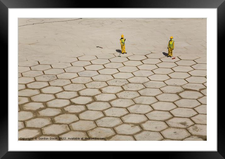Pushing hexagons ? - workers in Dubai grout large tiles in Dubai Framed Mounted Print by Gordon Dixon