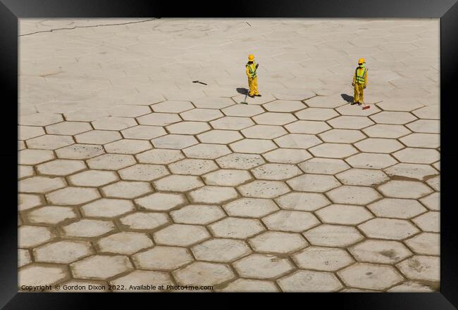 Pushing hexagons ? - workers in Dubai grout large tiles in Dubai Framed Print by Gordon Dixon