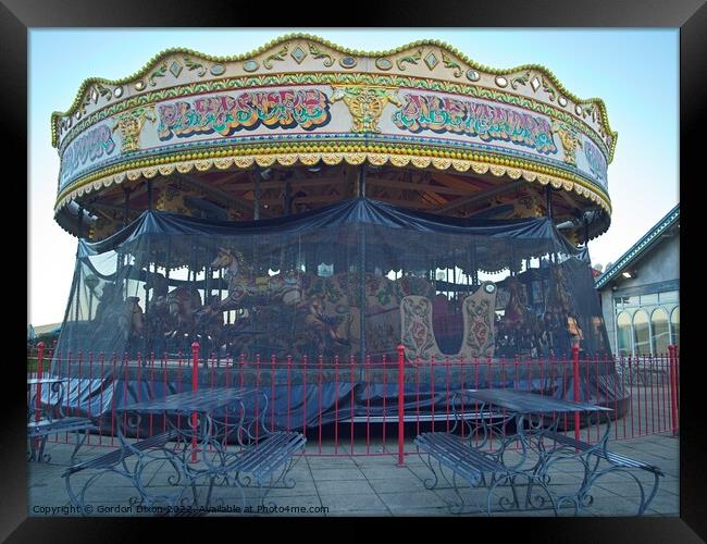 Carousel and it's horses put to bed for the winter at a funfair in Weymouth Framed Print by Gordon Dixon