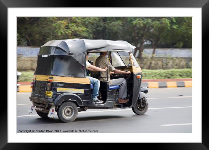 Autorickshaw driving down a road with passenger - Delhi, India Framed Mounted Print by Gordon Dixon