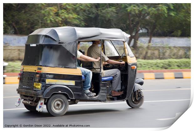Autorickshaw driving down a road with passenger - Delhi, India Print by Gordon Dixon