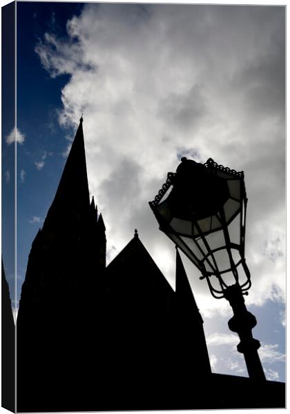 Iconic spire of Salisbury Cathedral and ornate street lamp in silhouette Canvas Print by Gordon Dixon