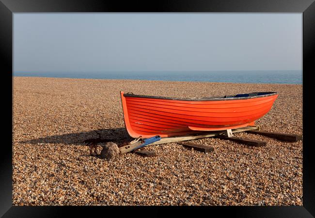 Small red fishing boat on shingle on Brighton beac Framed Print by Gordon Dixon