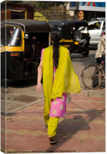 Traditionally dressed Indian lady walking along a street in Mumbai, India  Canvas Print by Gordon Dixon
