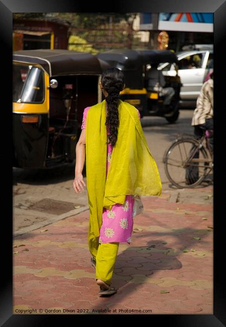 Traditionally dressed Indian lady walking along a street in Mumbai, India  Framed Print by Gordon Dixon