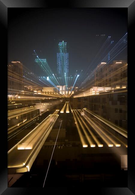 Zoomed image of skyscrapers at night in Dubai Framed Print by Gordon Dixon