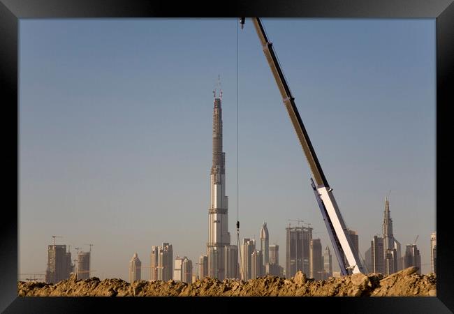 Checking it's vertical - Sheik Zayed Road skyline during construction of the Burj Khalifa, Dubai Framed Print by Gordon Dixon