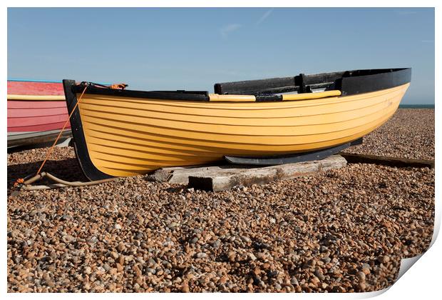 Yellow fishing boat on shingle  - Brighton beach Print by Gordon Dixon