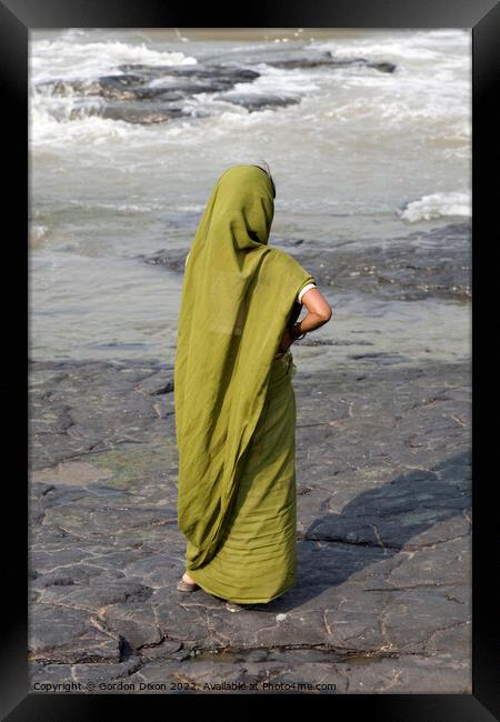 Indian lady dressed in green stands on a rock looking at the ocean - Mumbai  Framed Print by Gordon Dixon