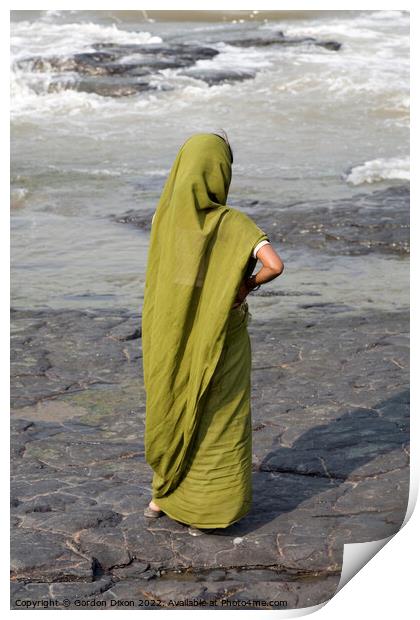 Indian lady dressed in green stands on a rock looking at the ocean - Mumbai  Print by Gordon Dixon