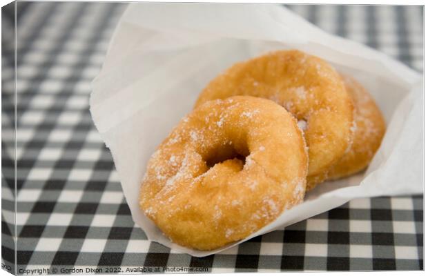 Freshly made doughnuts bought from a kiosk at West Bay, Dorset Canvas Print by Gordon Dixon