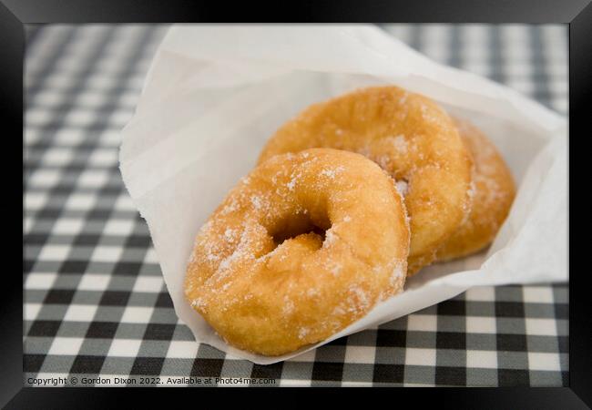 Freshly made doughnuts bought from a kiosk at West Bay, Dorset Framed Print by Gordon Dixon