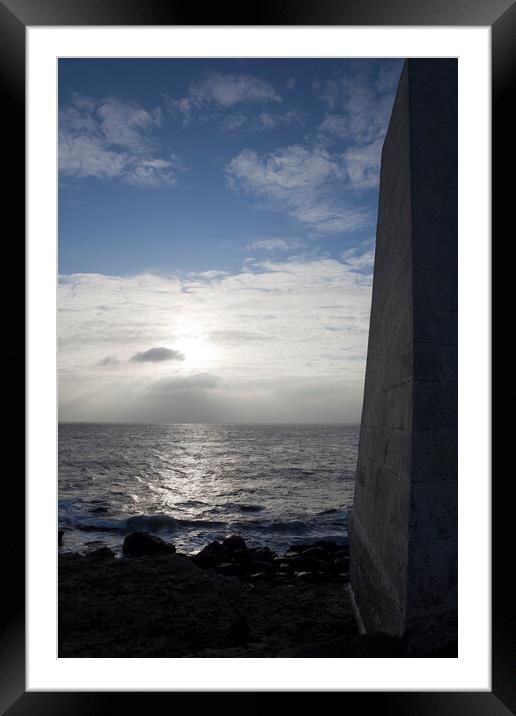 A dark obelisk looks over the sea at Portland Bill Dorset towards the setting sun Framed Mounted Print by Gordon Dixon