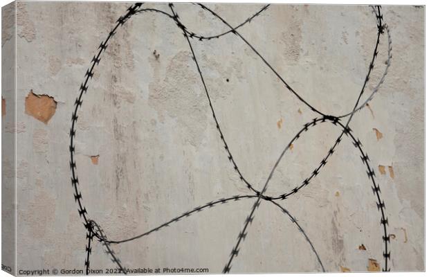 Razor wire outside an abandoned prison 's walls in Pudu, Kuala Lumpur. Canvas Print by Gordon Dixon