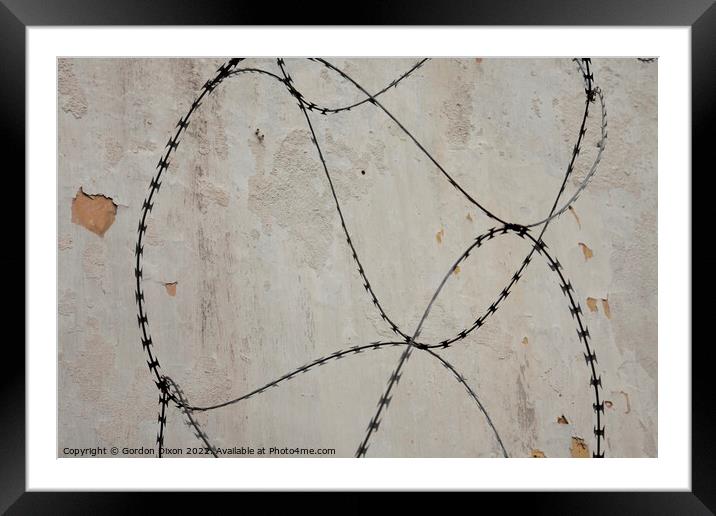 Razor wire outside an abandoned prison 's walls in Pudu, Kuala Lumpur. Framed Mounted Print by Gordon Dixon