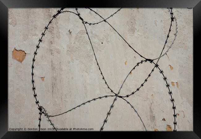 Razor wire outside an abandoned prison 's walls in Pudu, Kuala Lumpur. Framed Print by Gordon Dixon