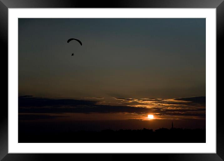 Powered paraglider pilot soars over the skyline of Istanbul at sunset Framed Mounted Print by Gordon Dixon