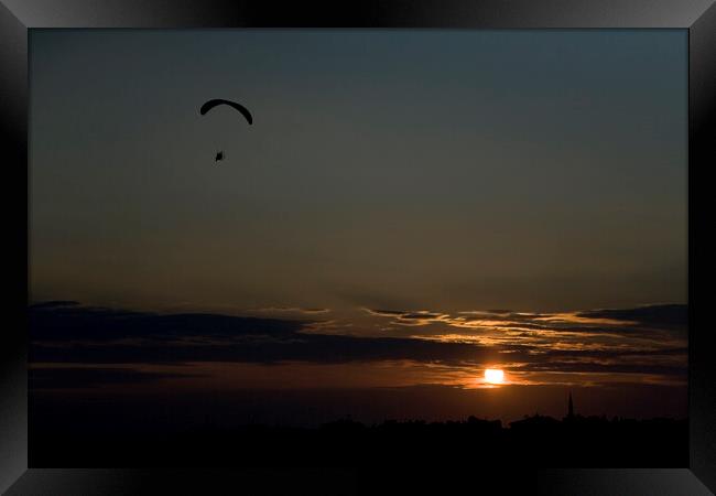 Powered paraglider pilot soars over the skyline of Istanbul at sunset Framed Print by Gordon Dixon