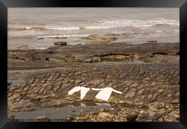 Lying flat out by the sea - laundry drying on rocks at Mumbai, India Framed Print by Gordon Dixon