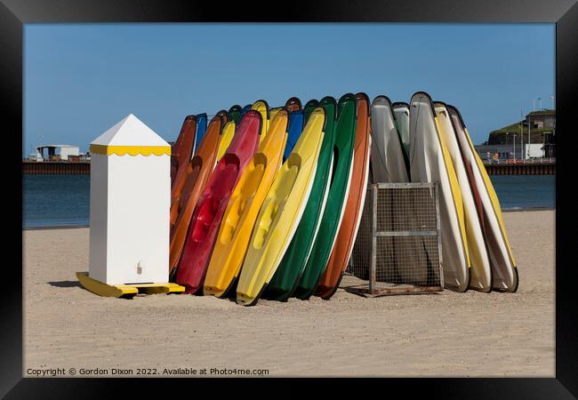 Colourful sit-on kayaks for hire on Weymouth beach Framed Print by Gordon Dixon