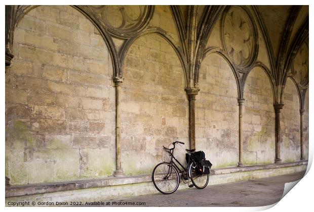 A priest's bicycle leaning up against a wall in the Cloister's Courtyard of Salisbury Cathedral, Wiltshire Print by Gordon Dixon