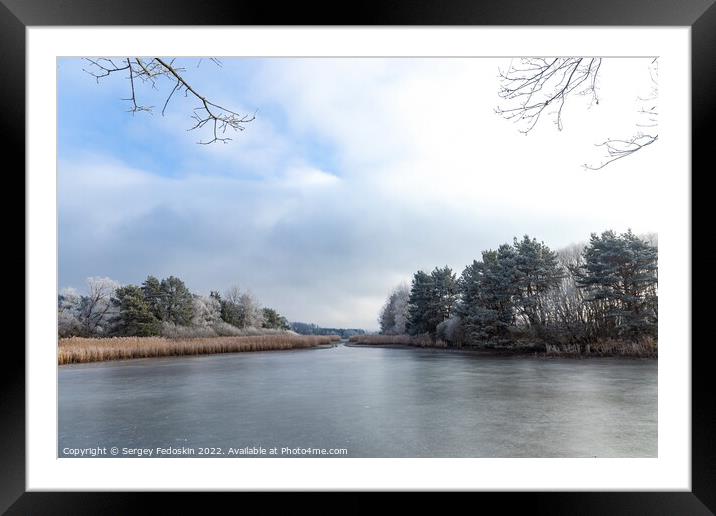 The frozen winter lake in wood under snow.  Framed Mounted Print by Sergey Fedoskin